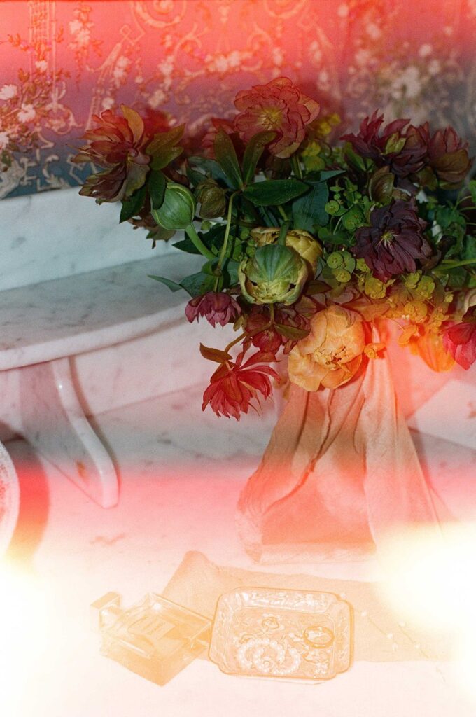 Film photograph of a bouquet with a warm light leak