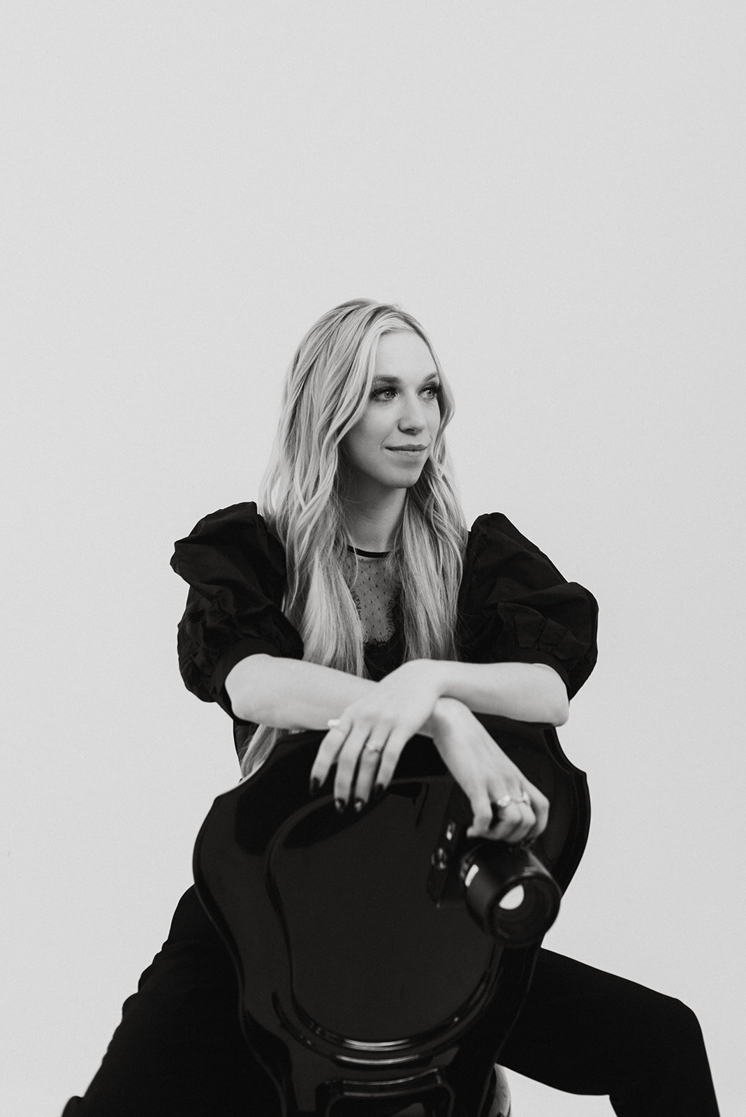 Jessica Combs, co-owner and host of The Visionaries House, holding a camera