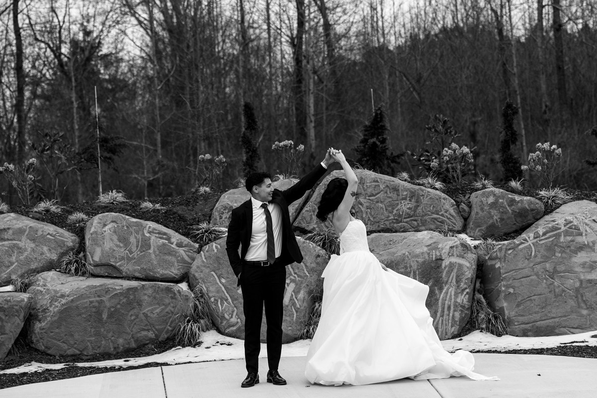 Black-and-white portrait of a couple dancing beside the rocks at The Sky Room
